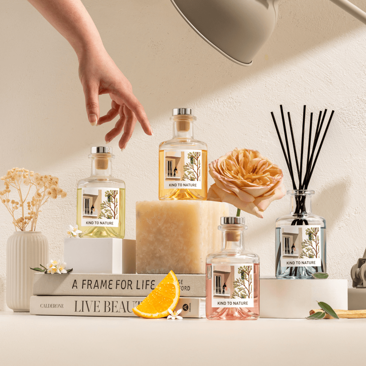 Elle Cadeaux luxury reed diffuser collection including Velvet Peony, styled with rose, orange slices and dried flowers on books